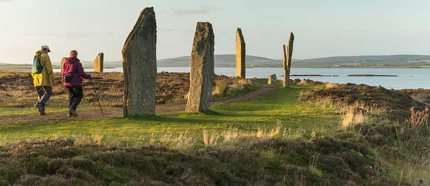 Ring of Brodger in Orkeny. Photo courtesy of Visit Scotland Senior couple hiking at the Ring of Brodger in Orkeny, Scotland