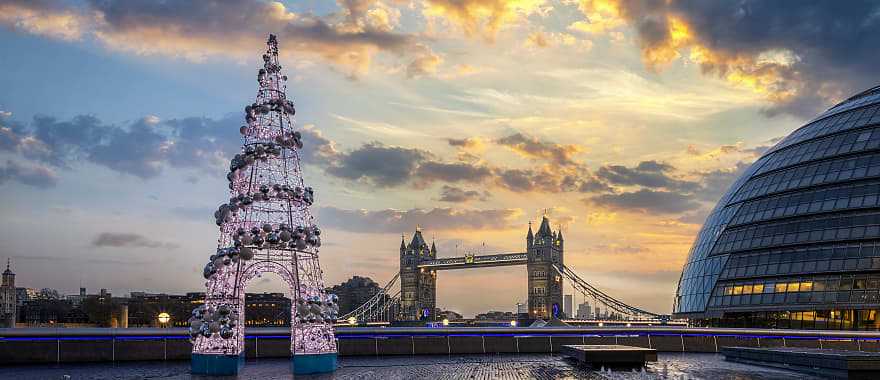 Winter sunrise in London with the Tower Bridge and festive Christmas tree