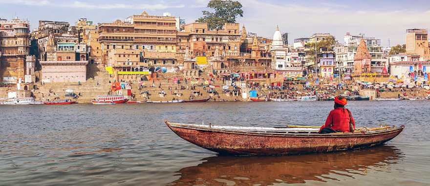 Sadhu on a wooden boat on river Ganges, India Sadhu on a wooden boat on river Ganges, India
