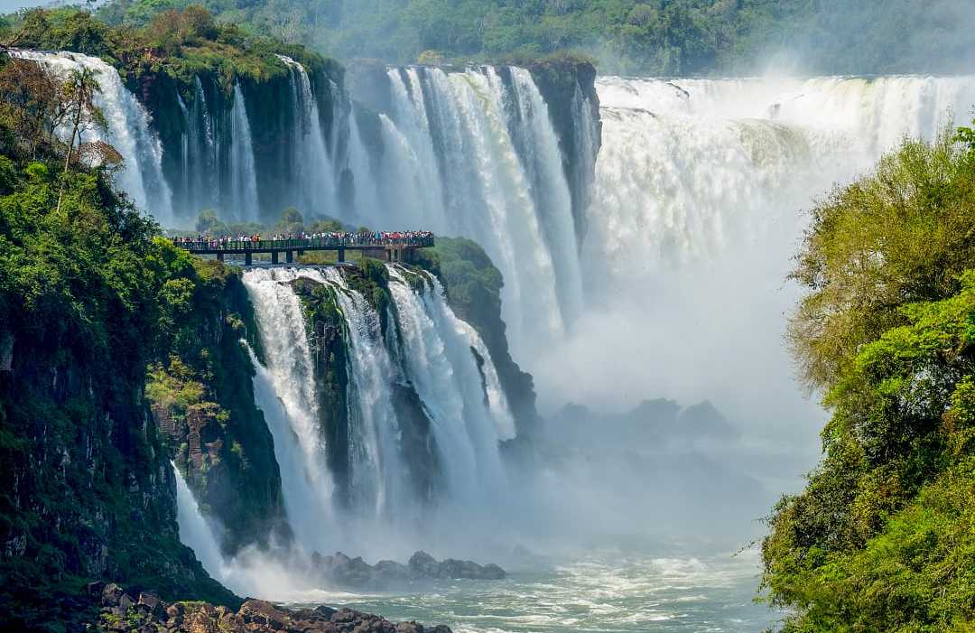 The Devil's Throat at Iguazu Falls, Argentina Travelers viewing The Devil's Throat from a platform on the Argentinian side of Iguazu Falls