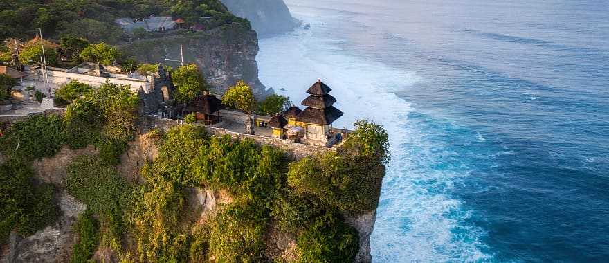 Cliffside Pura Luhur Uluwatu Temple at sunrise in Bali, Indonesia