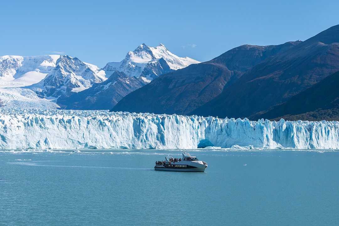 Ferry boat in front of Perito Moreno glacier in Argentina